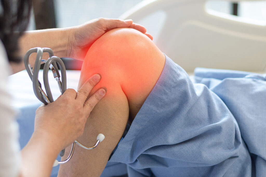 A patient having the knee assessed by a doctor