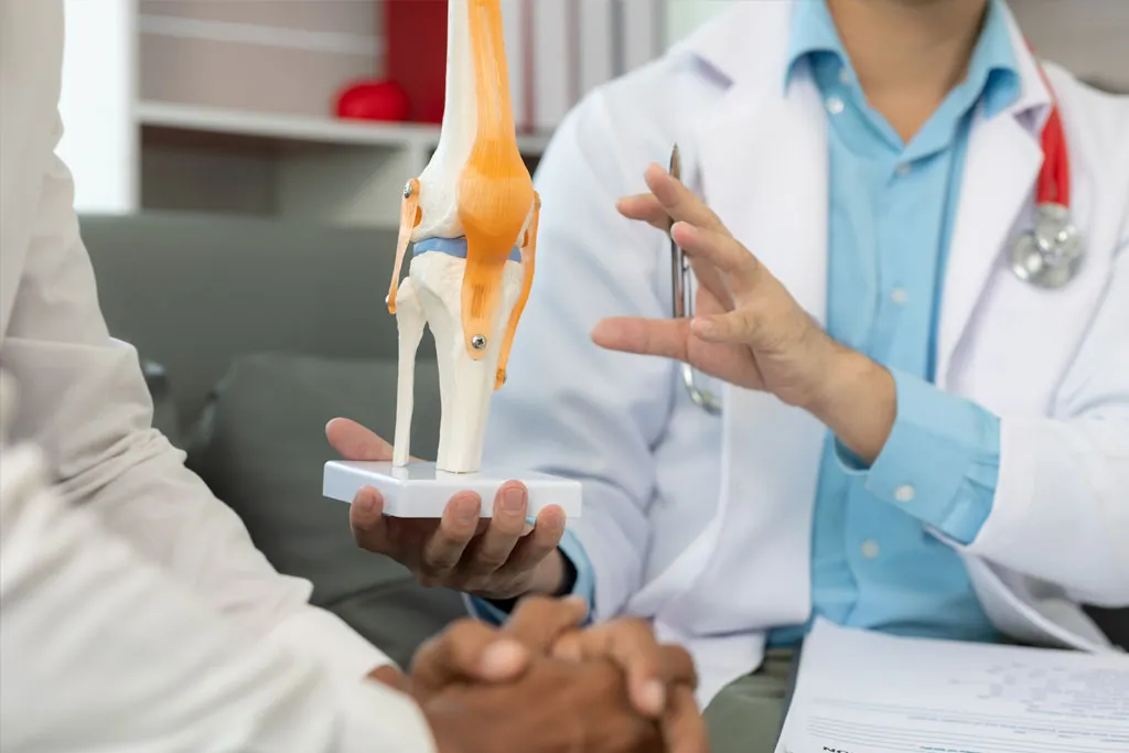 An orthopaedic surgeon in a consultation session with a patient