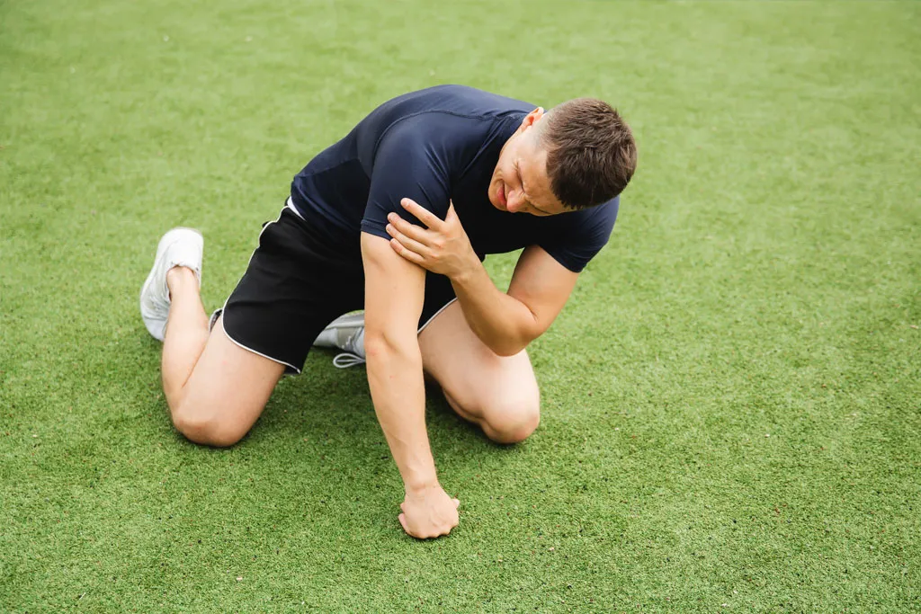 A man down with a shoulder injury whilst playing sports