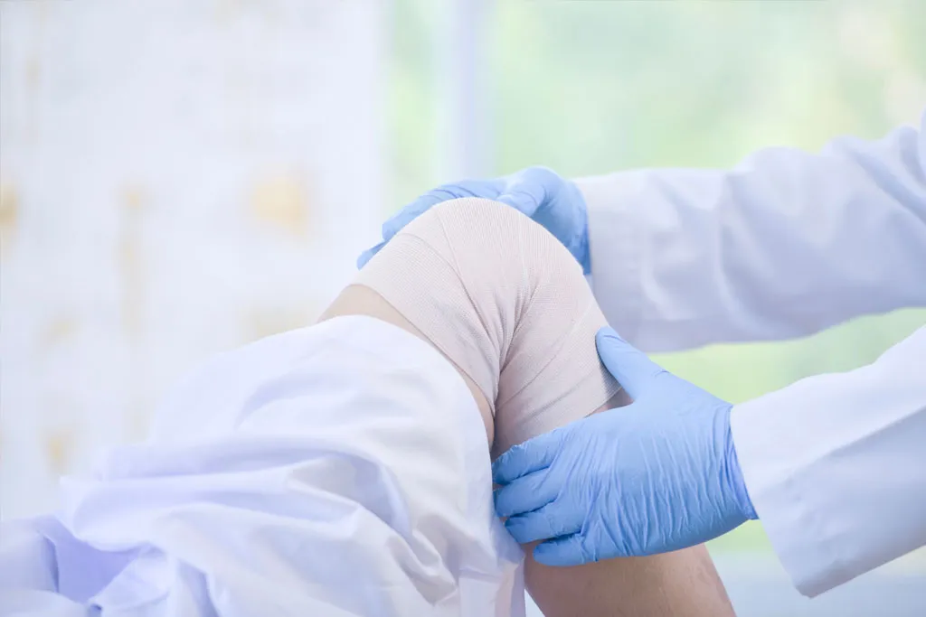 An orthopaedic surgeon providing treatment for a patient’s knee instability